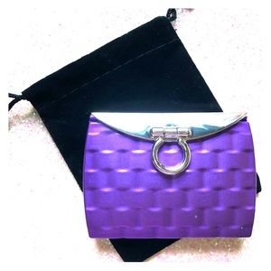 Purple compact mirror is double sided.